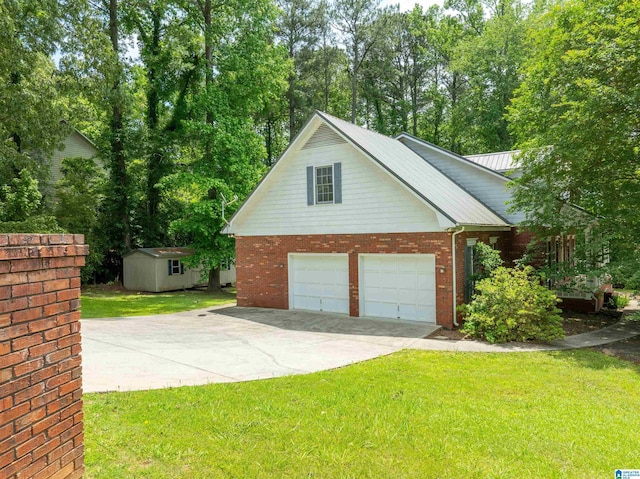 garage with a storage shed, driveway, and view of scattered trees