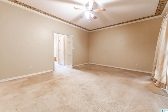empty room featuring a ceiling fan, ornamental molding, light carpet, and baseboards