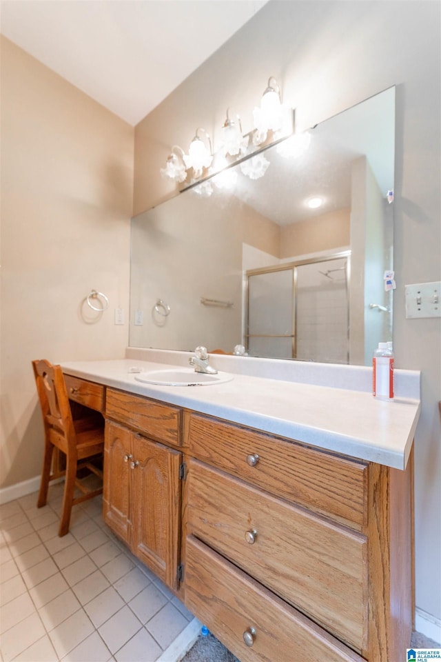 full bath featuring vanity, a shower stall, tile patterned flooring, and baseboards