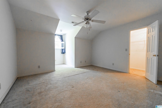 additional living space featuring vaulted ceiling, a ceiling fan, carpet, and baseboards