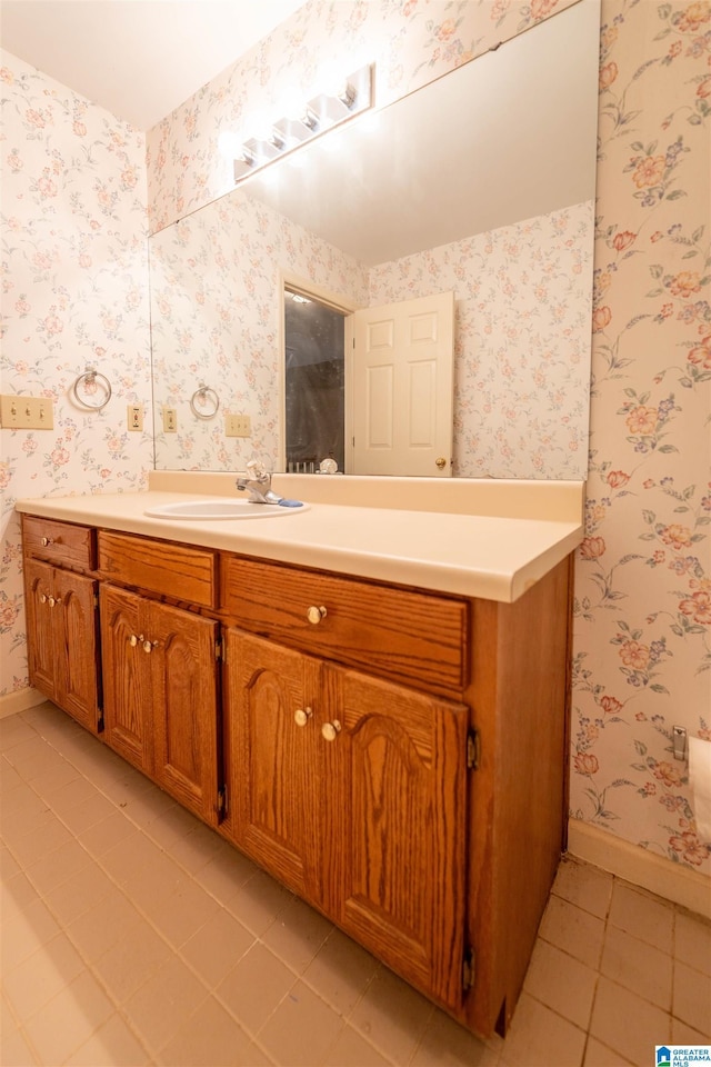 bathroom with tile patterned flooring, baseboards, and vanity