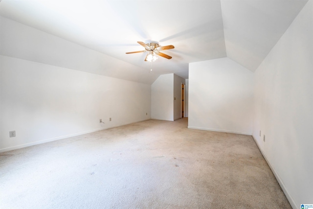 additional living space featuring light carpet, ceiling fan, lofted ceiling, and baseboards