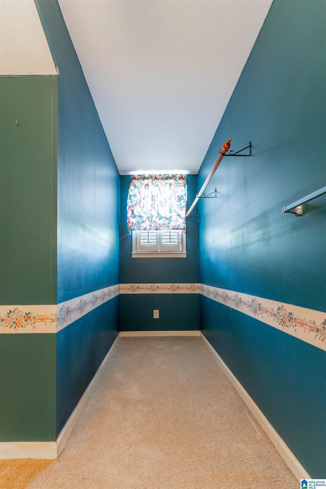 carpeted spare room featuring baseboards