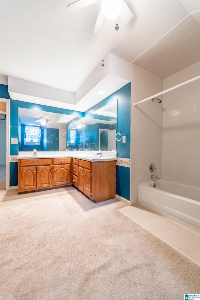 bathroom with vanity, bathing tub / shower combination, ceiling fan, and carpet flooring