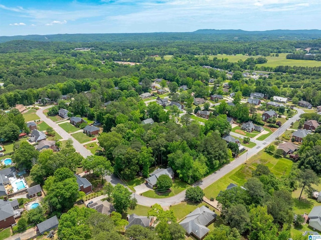 aerial view of residential area featuring a heavily wooded area