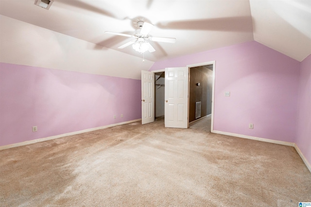 additional living space featuring vaulted ceiling, light colored carpet, ceiling fan, and baseboards