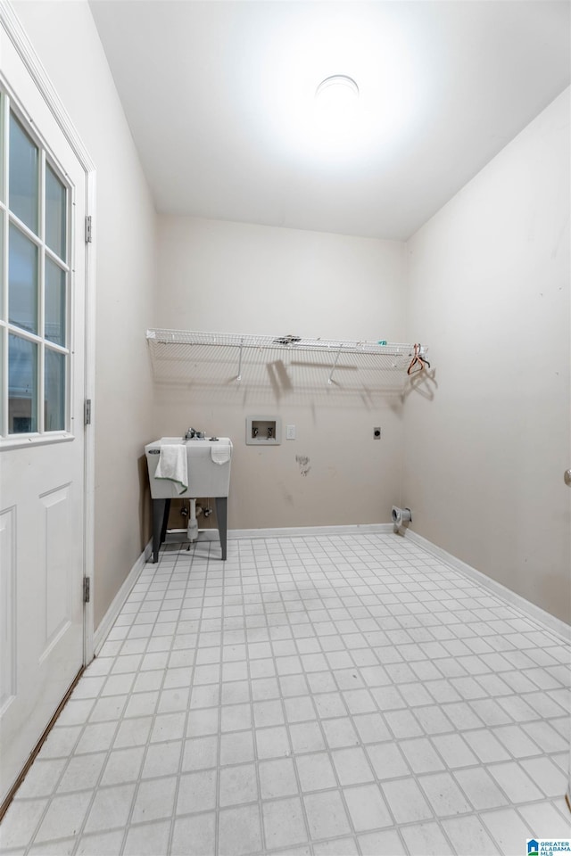 clothes washing area with electric dryer hookup, hookup for a washing machine, and baseboards