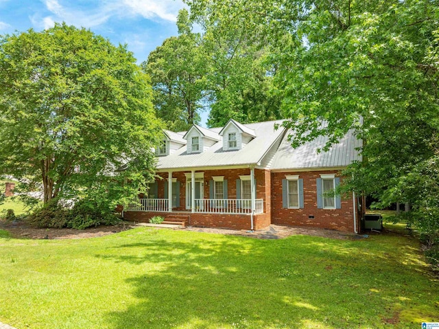 cape cod-style house with covered porch, a front yard, brick siding, and metal roof
