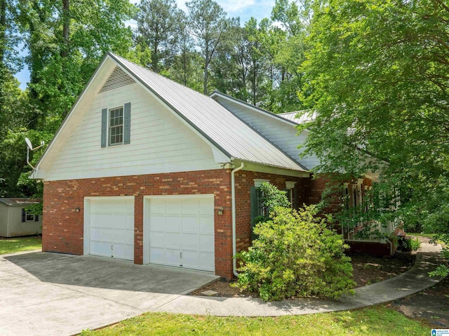 view of side of property featuring brick siding, concrete driveway, and a garage