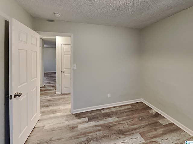 1424 33rd St, Ensley, Birmingham, AL 35218 - spare room with wood finished floors, a textured ceiling, baseboards, and a smoke detector