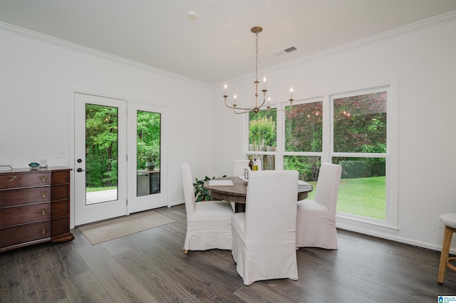 dining room with a chandelier, crown molding, dark wood-style floors, and baseboards