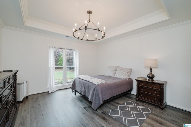 bedroom featuring a raised ceiling, a chandelier, dark wood-type flooring, crown molding, and radiator heating unit