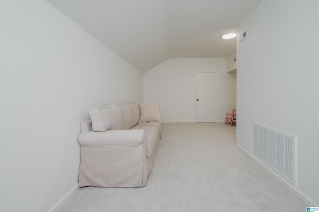 sitting room featuring carpet, lofted ceiling, and baseboards