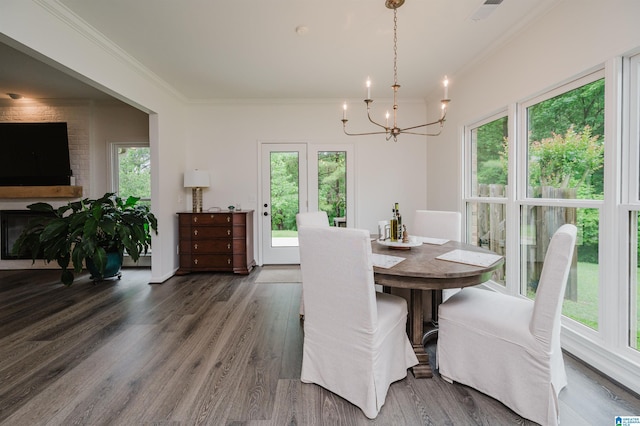 dining space featuring a chandelier, crown molding, and wood finished floors