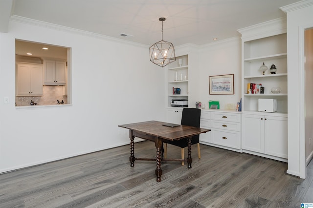 home office with dark wood-type flooring, crown molding, built in shelves, a chandelier, and recessed lighting