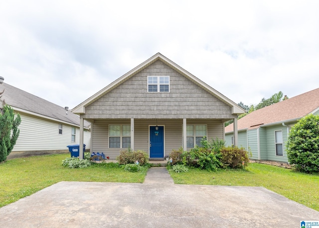bungalow featuring a front lawn and a porch
