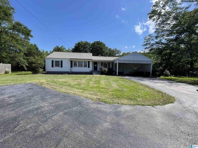 2020 Warrior Jasper Rd, Warrior, AL 35180 - ranch-style house featuring asphalt driveway, a front lawn, and a carport