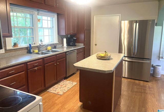 2020 Warrior Jasper Rd, Warrior, AL 35180 - kitchen with appliances with stainless steel finishes, a sink, light wood finished floors, a center island, and light countertops