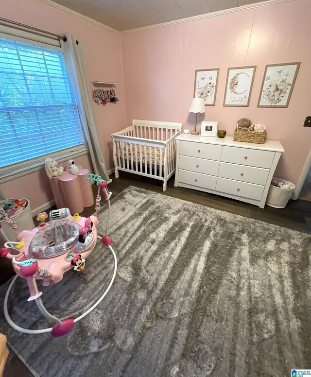 2020 Warrior Jasper Rd, Warrior, AL 35180 - bedroom featuring crown molding, a crib, and wood finished floors