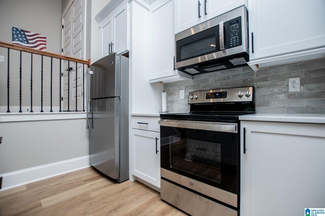 90 Landing Chase, Wedowee, AL 36278 - kitchen with appliances with stainless steel finishes, light wood-style floors, white cabinetry, and tasteful backsplash