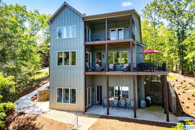 90 Landing Chase, Wedowee, AL 36278 - rear view of house featuring a balcony, a patio area, and board and batten siding