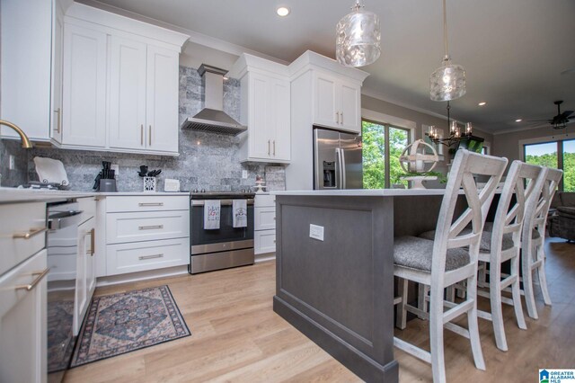 90 Landing Chase, Wedowee, AL 36278 - kitchen featuring appliances with stainless steel finishes, ornamental molding, wall chimney range hood, decorative backsplash, and white cabinets