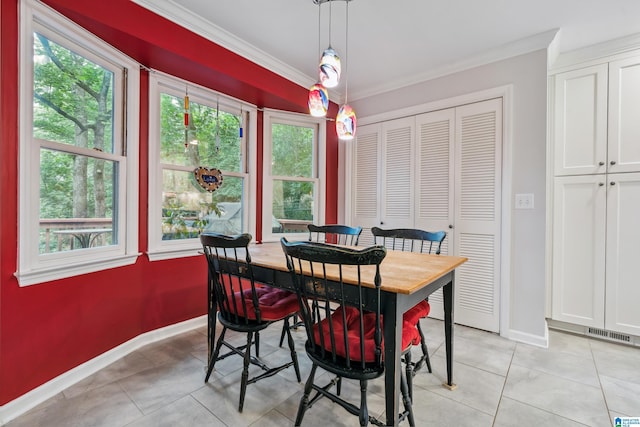 dining space with crown molding, baseboards, and light tile patterned floors