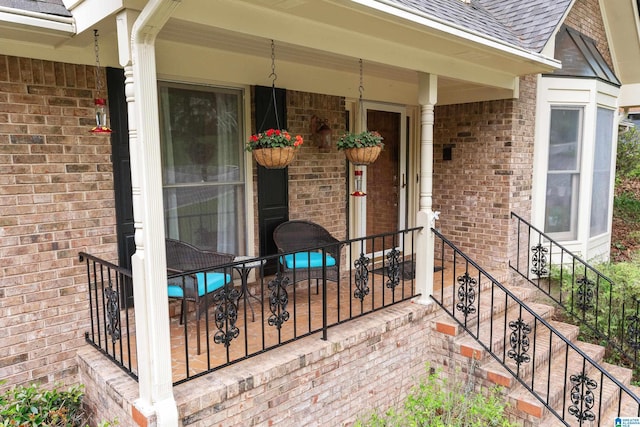 entrance to property with brick siding and roof with shingles