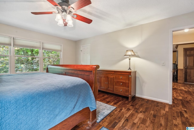 bedroom with dark wood finished floors, baseboards, and a ceiling fan