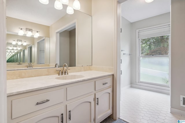 bathroom featuring baseboards, vanity, and tile patterned floors