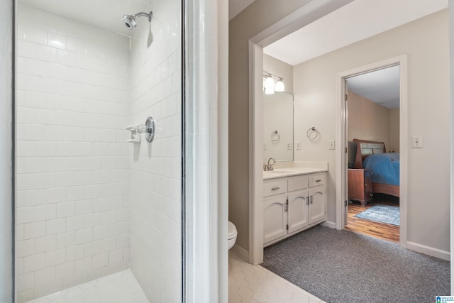 full bath featuring a shower stall, vanity, ensuite bathroom, and tile patterned flooring