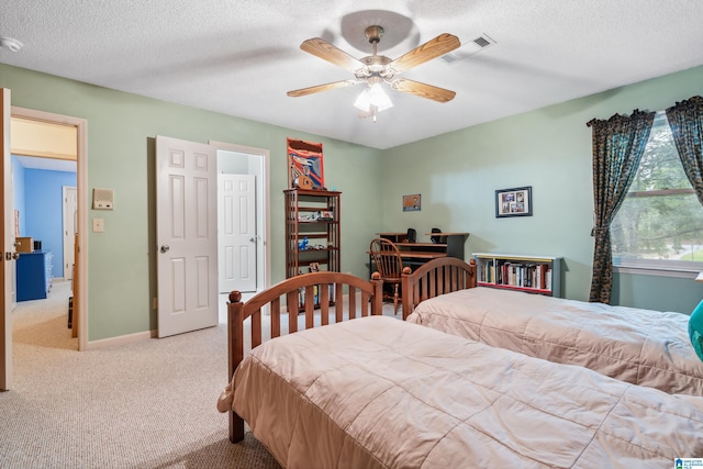 bedroom with carpet flooring, a textured ceiling, a ceiling fan, and baseboards