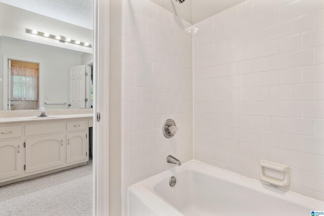 bathroom featuring bathing tub / shower combination and vanity