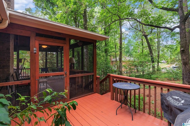 wooden deck with a sunroom