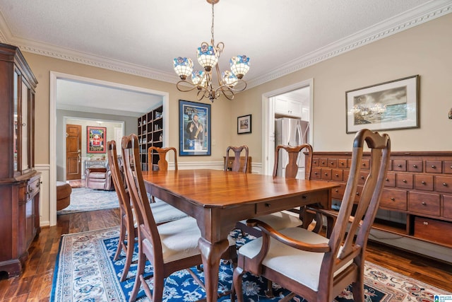 dining space featuring a chandelier, crown molding, dark wood-style flooring, and a textured ceiling