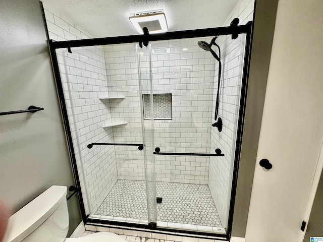 2825 Highland Ave S Unit 1, Birmingham, AL 35205 - full bath featuring toilet, a stall shower, and a textured ceiling