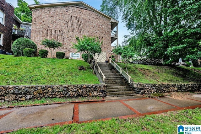 2825 Highland Ave S Unit 1, Birmingham, AL 35205 - view of home's exterior featuring a yard, stairs, a balcony, and brick siding