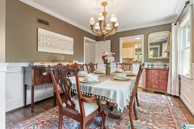 117 Morris Blvd, Homewood, AL 35209 - dining room featuring a chandelier, wood finished floors, crown molding, a decorative wall, and a wainscoted wall