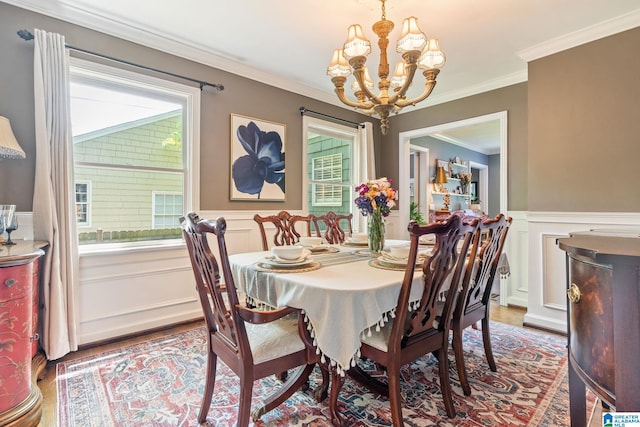117 Morris Blvd, Homewood, AL 35209 - dining area with a chandelier, wood finished floors, a wainscoted wall, ornamental molding, and a decorative wall