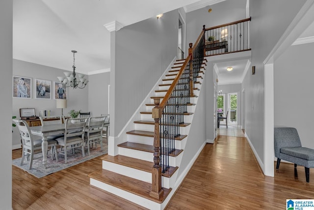 1408 W Acorn Way, Mount Olive, AL 35117 - stairs featuring wood finished floors, a chandelier, baseboards, and ornamental molding