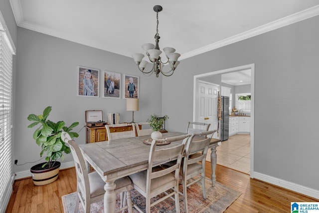 1408 W Acorn Way, Mount Olive, AL 35117 - dining space with a chandelier, ornamental molding, baseboards, and light wood-style flooring