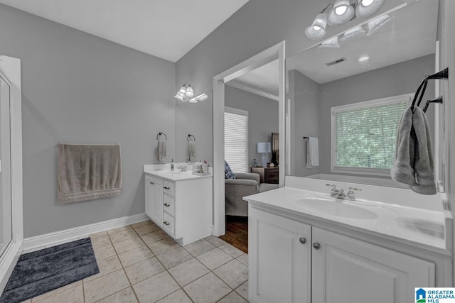 1408 W Acorn Way, Mount Olive, AL 35117 - bathroom featuring two vanities, plenty of natural light, tile patterned flooring, and baseboards