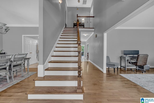 1408 W Acorn Way, Mount Olive, AL 35117 - staircase featuring ornamental molding, a towering ceiling, wood finished floors, and baseboards