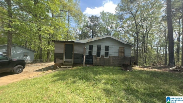 view of front of house with entry steps and a front lawn