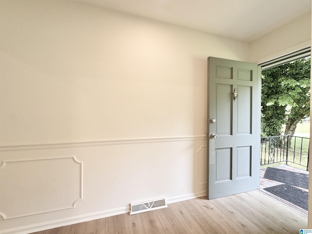 spare room with wood finished floors and baseboards