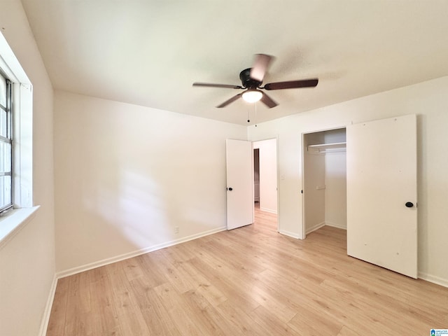 unfurnished bedroom with light wood finished floors, baseboards, a closet, and a ceiling fan