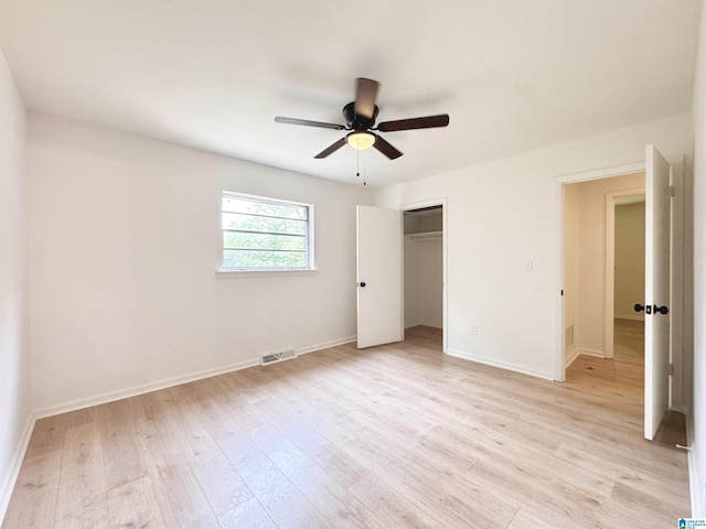 unfurnished bedroom featuring light wood-style floors, baseboards, a closet, and a ceiling fan