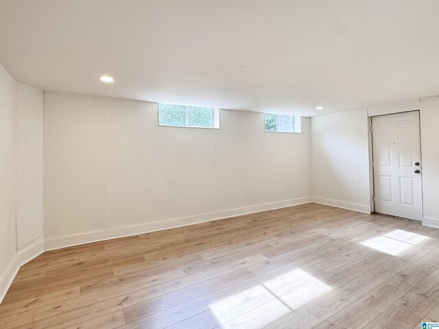 below grade area featuring light wood-style flooring, baseboards, and recessed lighting