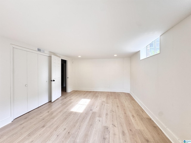 below grade area with light wood finished floors, baseboards, and recessed lighting