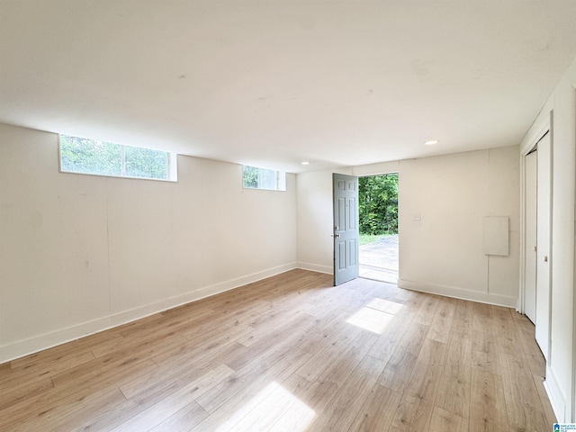 unfurnished bedroom with light wood-style flooring, access to outside, and baseboards